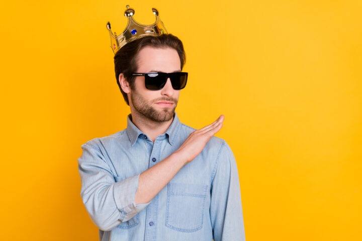 Hombre con corona, gafas de sol y gesto altivo. Ilustra rasgos narcisistas: egocentrismo, grandiosidad.