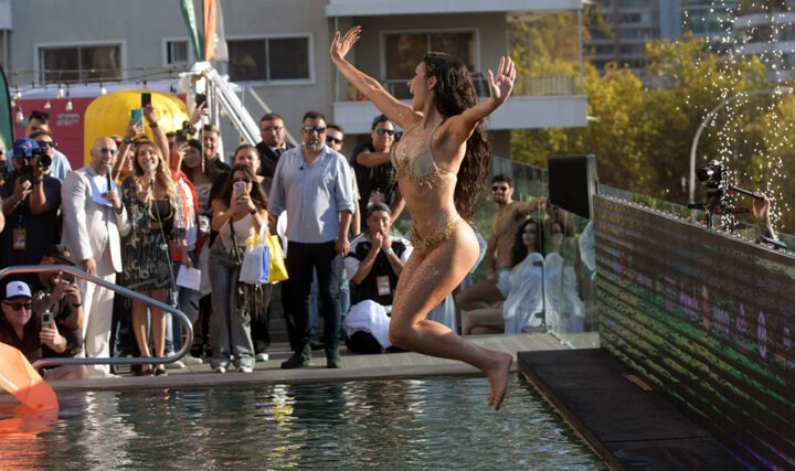 Emilia Dides, Reina de Viña 2025, salta al piscinazo en bikini dorado con brillos. Periodistas la fotografían.