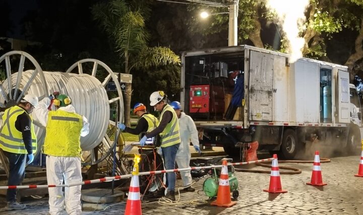 Rehabilitación de alcantarillado sin zanja por Esval, evitando romper calles. Equipo con carrete y camión en obra nocturna.