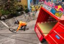 Ciclista de MTB en pleno descenso urbano Red Bull Valparaíso Cerro Abajo, con contenedor rojo OXXO y público.