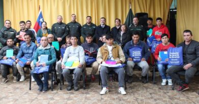 Grupo de internos de Gendarmería recibiendo útiles escolares en el Centro de Cumplimiento Penitenciario de Los Andes.