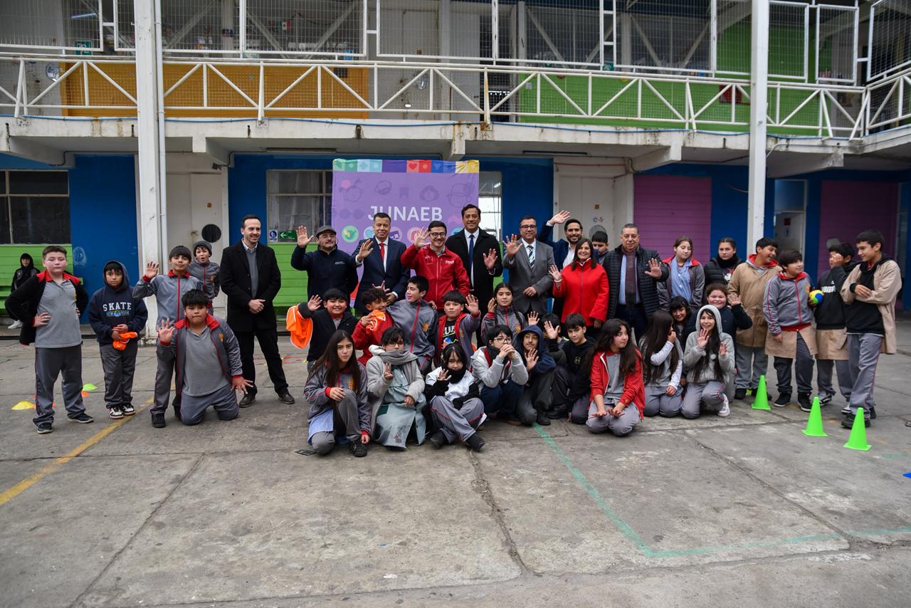 Grupo de estudiantes, docentes y autoridades posando en el patio de la Escuela España en Valparaíso.