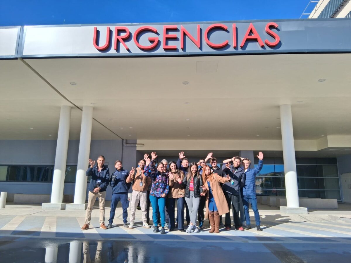 Grupo de médicos posando frente a la entrada principal del Hospital Provincial Marga Marga con el letrero de 'URGENCIAS'.