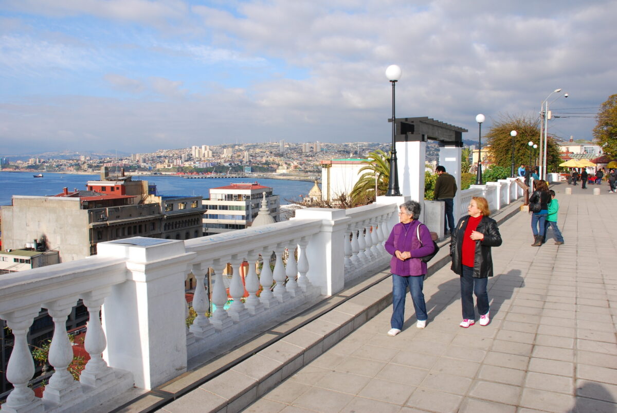 Turistas paseando por el paseo de Valparaíso con vista al mar