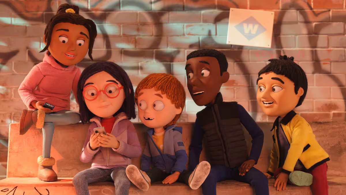 Grupo de niños de la película Olivia y el terremoto invisible sentados conversando frente a una pared con grafitis.