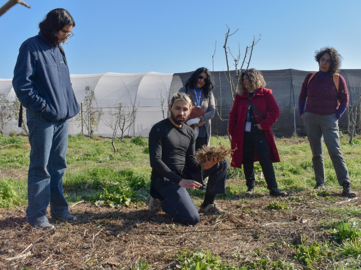 Profesional realizando una demostración técnica sobre manejo de suelos y agroecología durante la jornada.