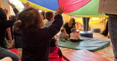 Niños explorando con telas de colores en una actividad sensorial en el museo Artequin.